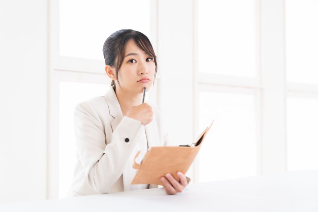 ピル服用中の生理はいつくるのか考えている女性。手帳をチェックしている