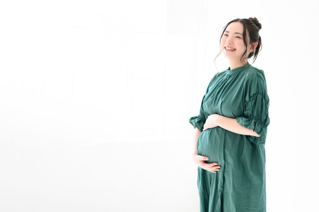 お腹を押さえて笑顔の女性