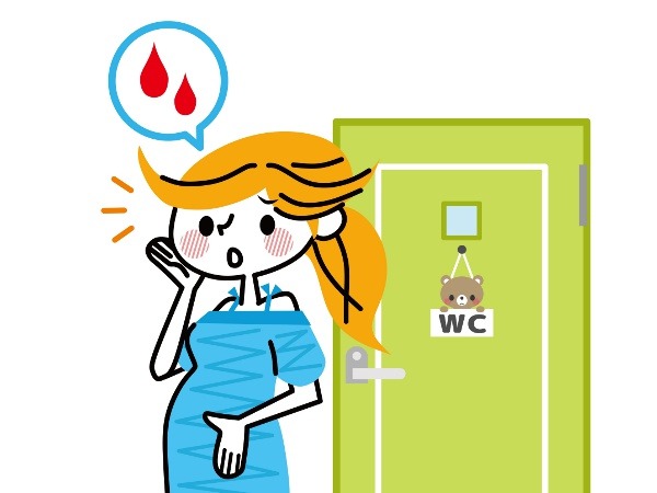 トイレでの出血に気付いた妊婦のイラスト