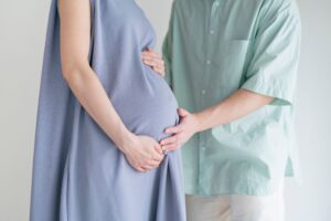 妊婦のお腹に触れる夫